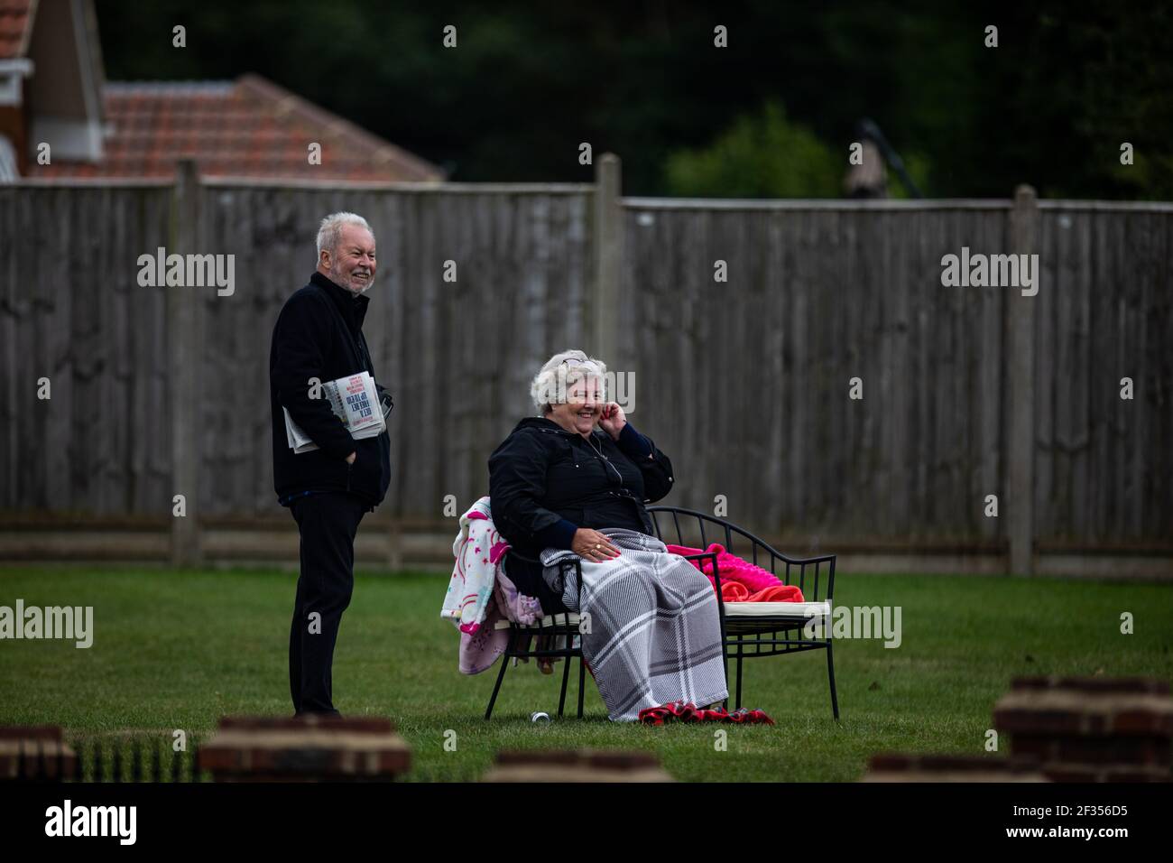 Member of public watching from there home during the Investec Handicap race at Epsom Racecourse Stock Photo