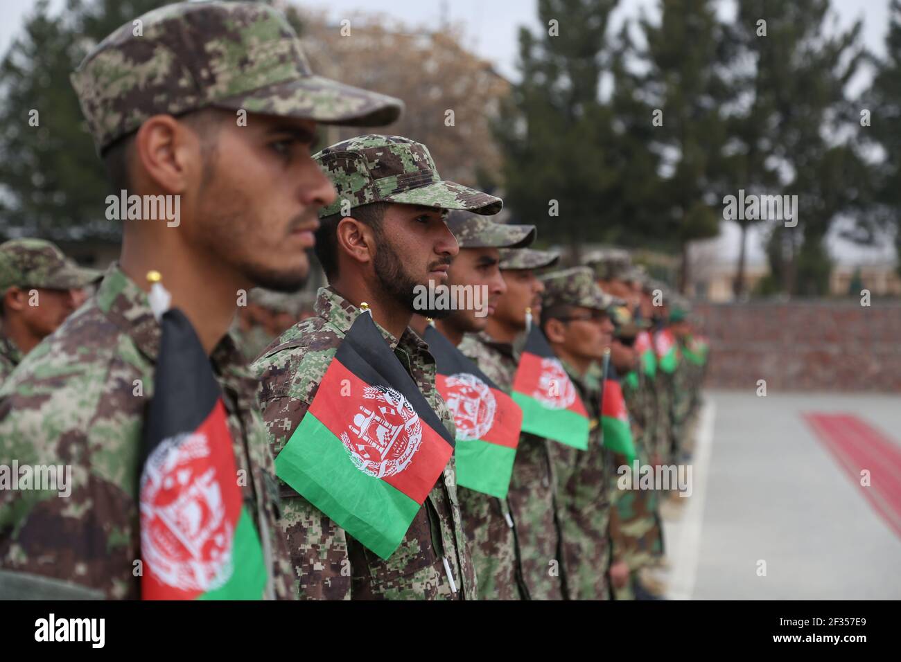 Kabul, Afghanistan. 15th Mar, 2021. Afghan soldiers take part in their graduation ceremony in Kabul, Afghanistan, March 15, 2021. A total of 1,057 newly graduated soldiers have been commissioned to the Afghan national army here on Monday. Credit: Sayed Mominzadah/Xinhua/Alamy Live News Stock Photo