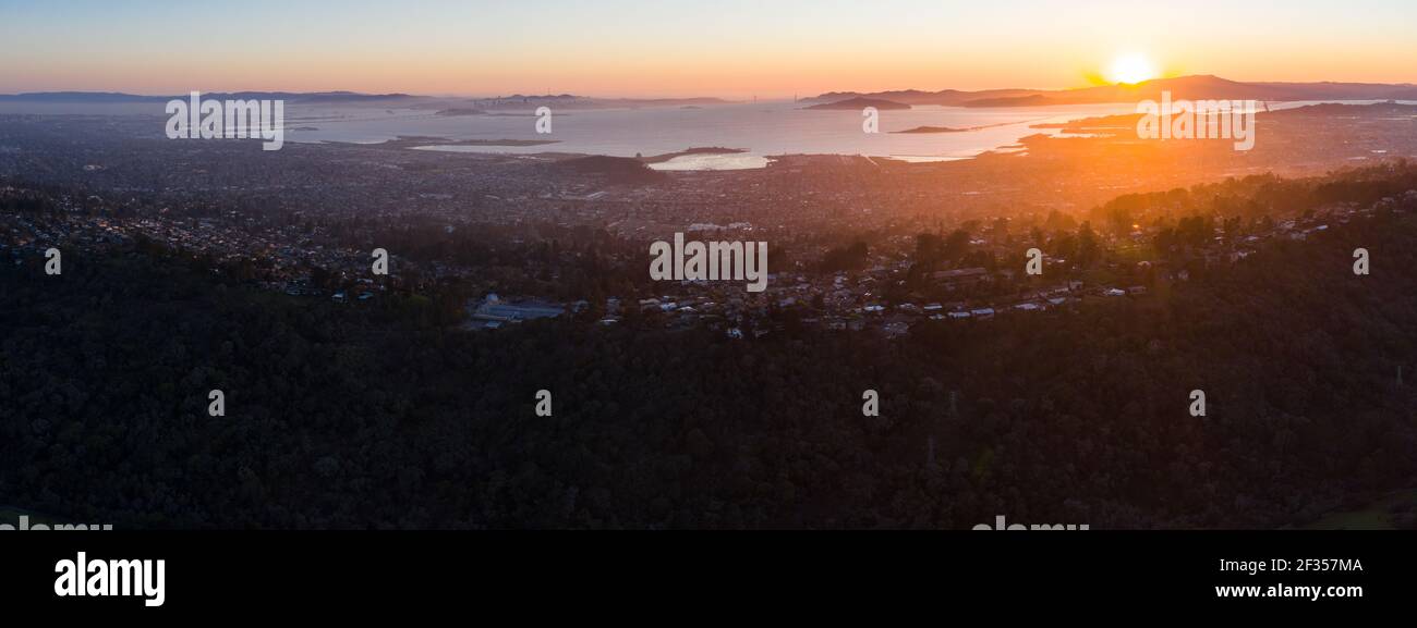 The last light of day illuminates San Francisco Bay and its surrounding cities and hills. This area is bordered by open space in the East Bay. Stock Photo