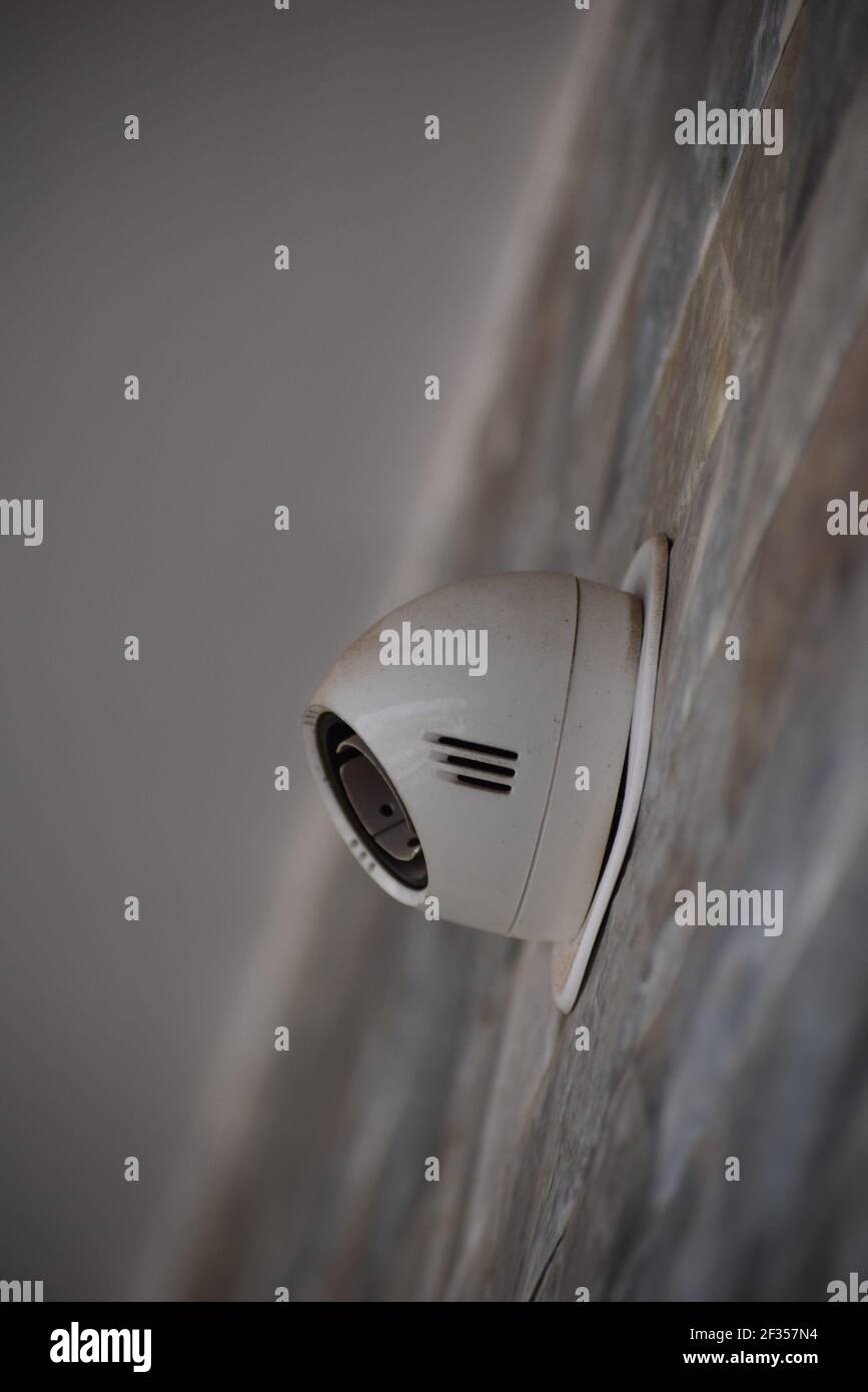 A vertical shot of a modern CCTV security camera on the wall Stock ...