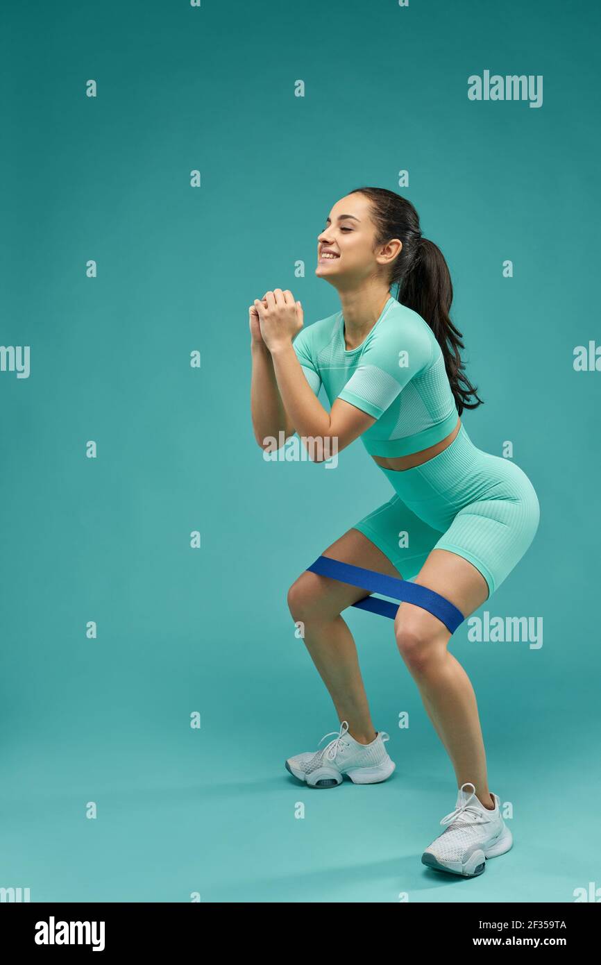 Sporty young woman doing exercise with resistance band Stock Photo
