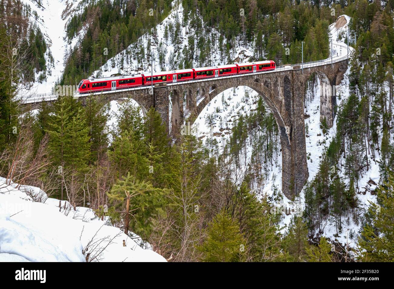 Train passing Wiesen Viaduct, Rhaetian railway, Graubunden, Switzerland Stock Photo