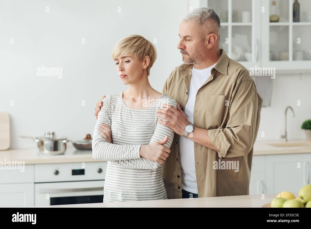 Reassuring spouse after quarrel or bad news, human emotions and problems in family relationships at home Stock Photo