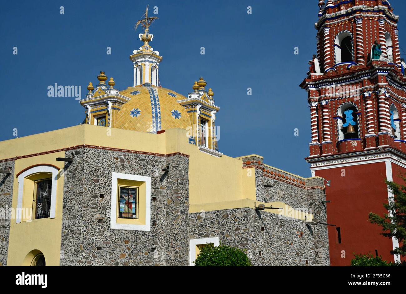 Cupola and bell tower view of the Baroque church Santa María Tonantzintla in Cholula, Puebla Mexico. Stock Photo