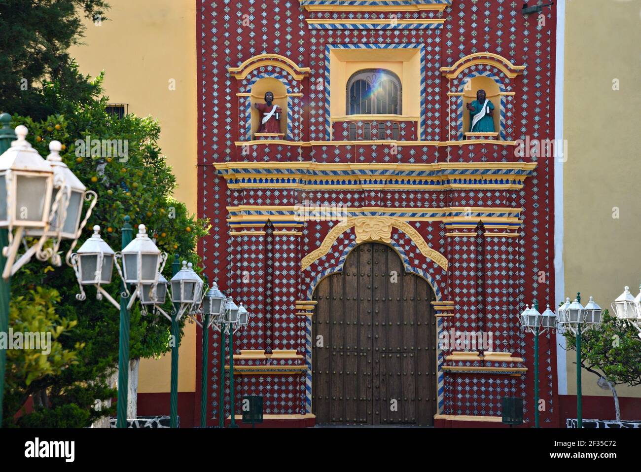 Talavera tile and ochre stucco facade view of the ancient Baroque church Santa María Tonantzintla in Cholula, Puebla Mexico. Stock Photo