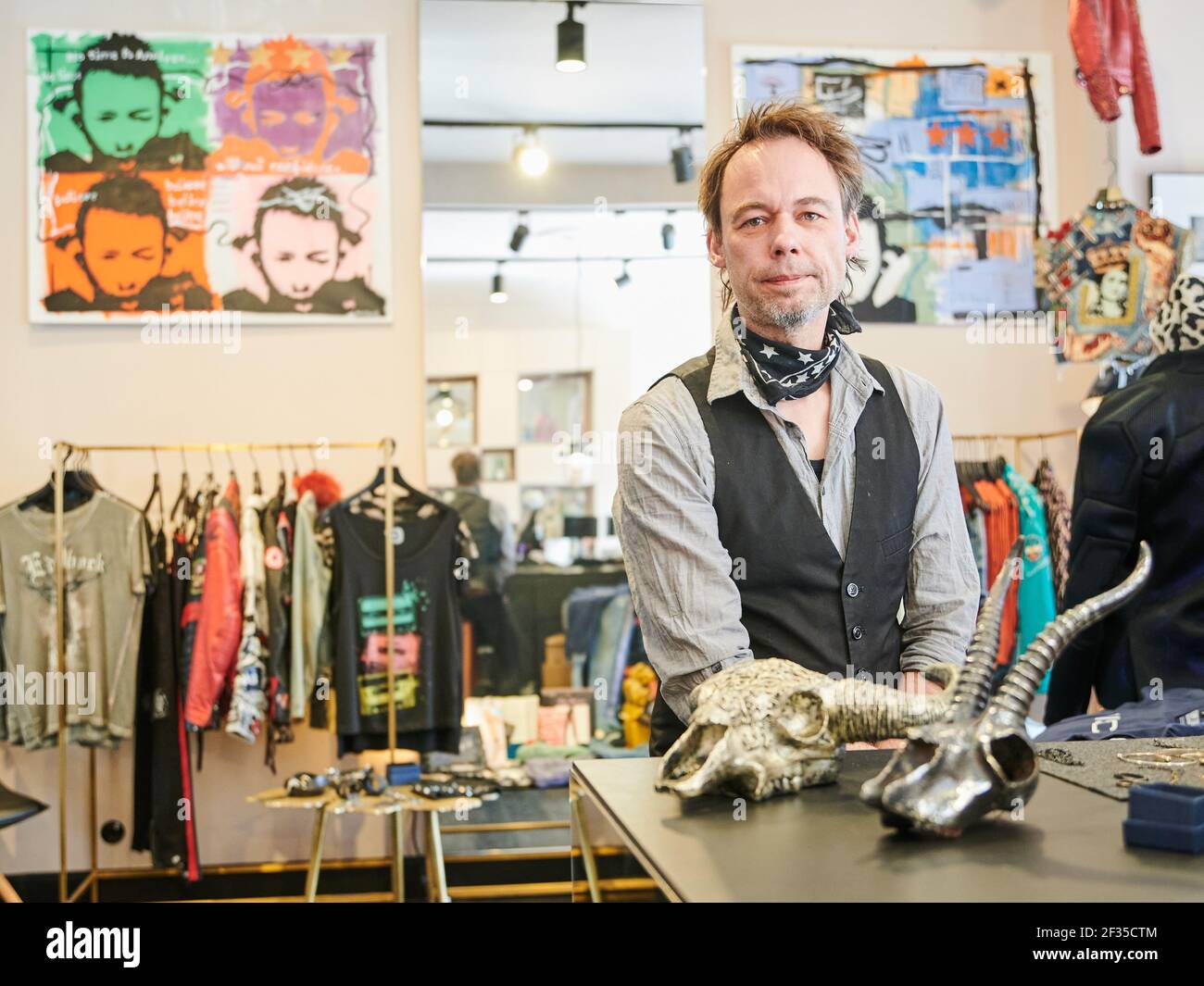 Berlin, Germany. 15th Mar, 2021. Marius, owner of the shop "Toni and the  blue elephant" sits in his shop in Berlin Mitte. With "Clique & Meet" you  can buy art and design