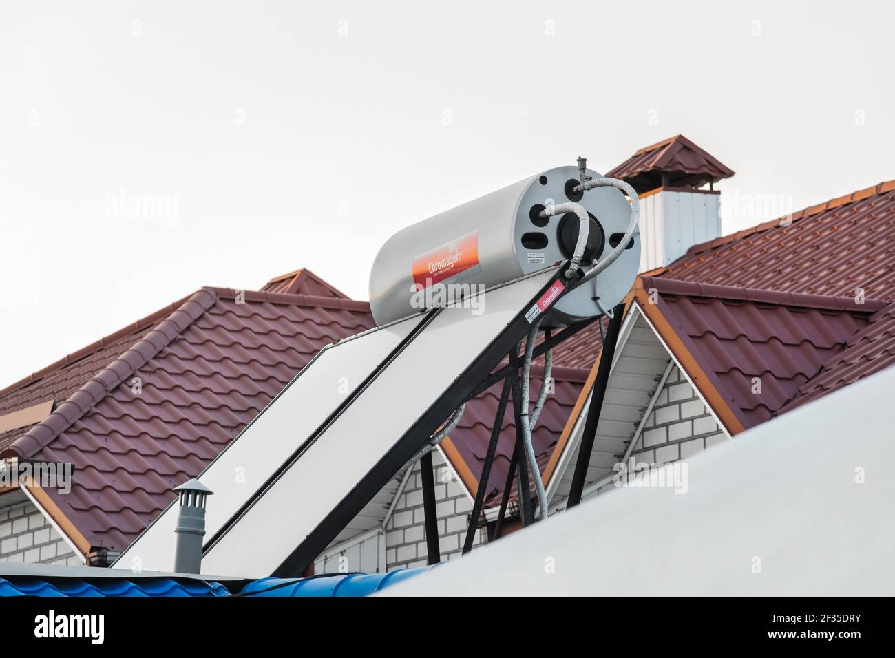Ukraine, Iron Port - August 22, 2020: Solar water heater on the roof of a building against the background of the sky. Using solar energy to heat water Stock Photo