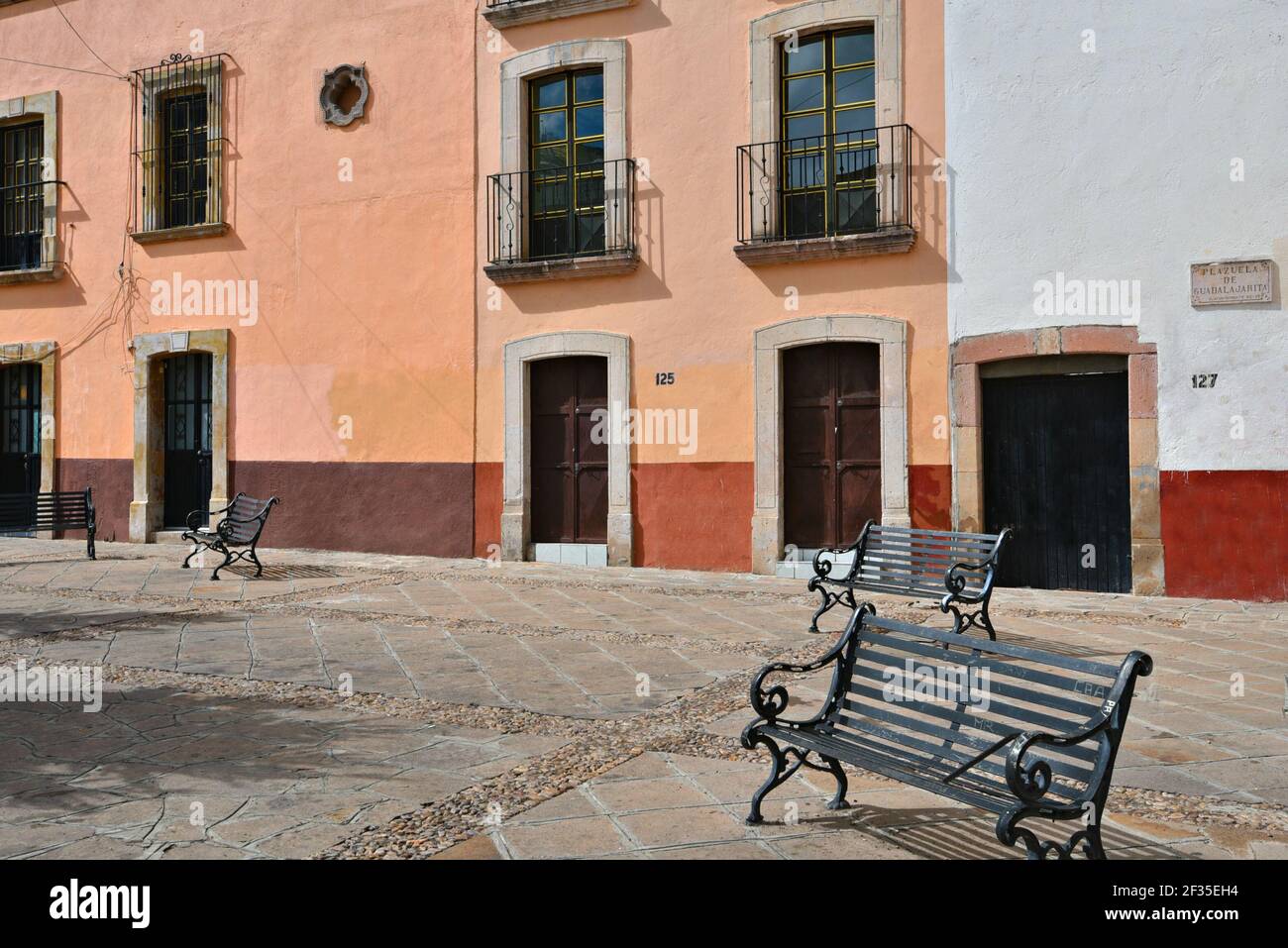Picturesque quarry plaza with wrought iron benches and Colonial houses