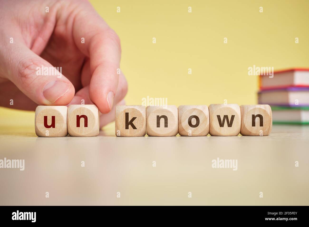 Know and unKnow Concept on Wooden Cubes. Stock Photo