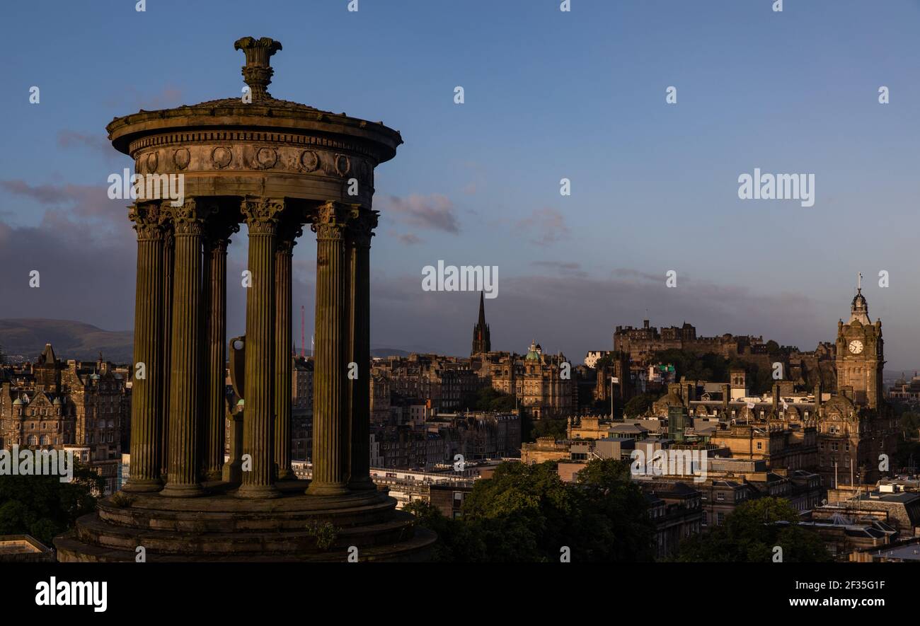 General view of Dugald Stewart Monument and the Edinburgh skyline from Calton Hill at sunrise, Scotland Stock Photo