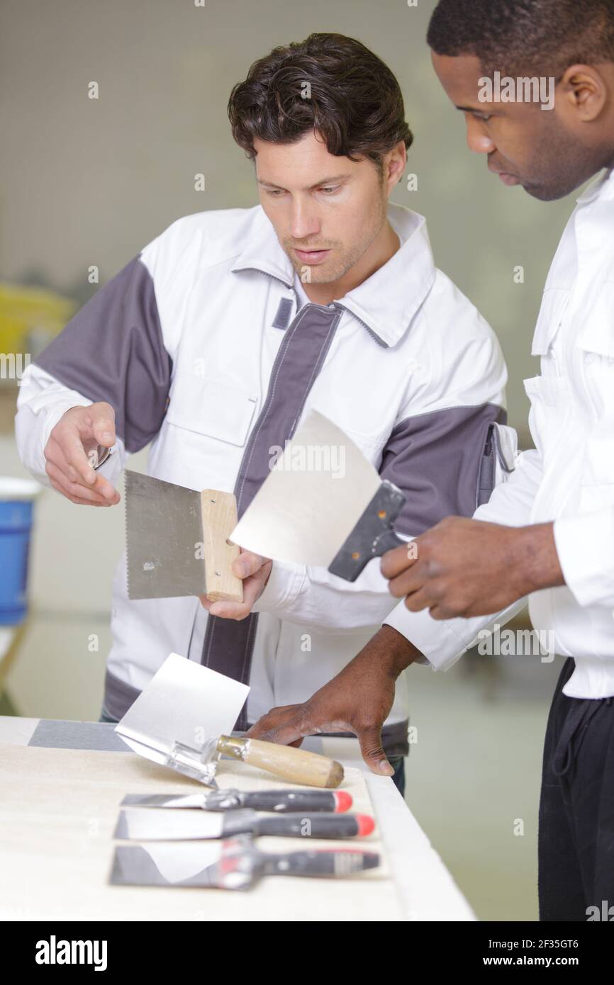 apprentice is learning to use a brush Stock Photo