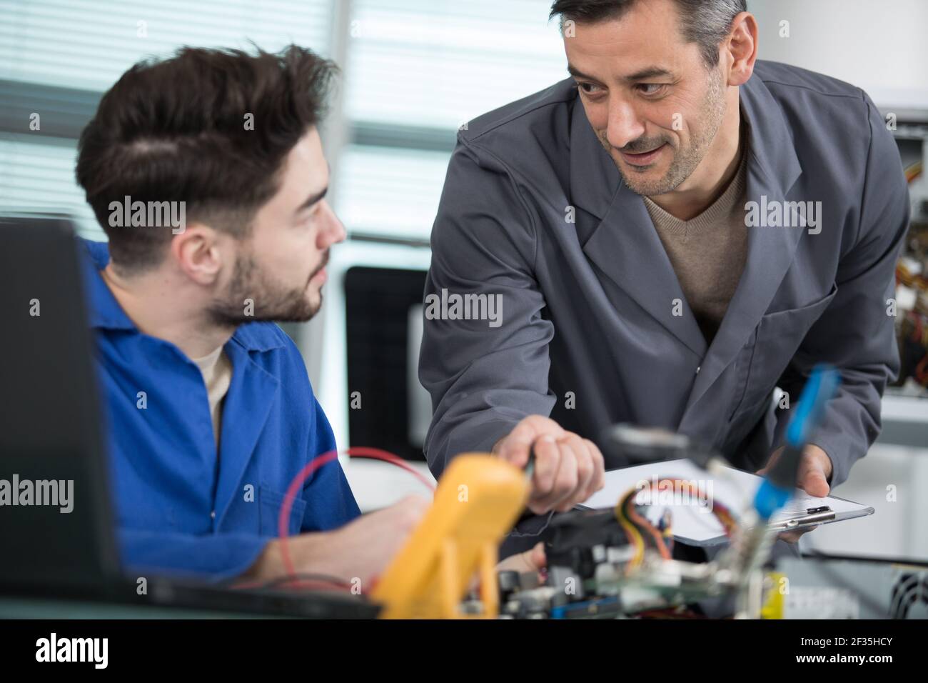 young apprentice electrician using multimeter Stock Photo