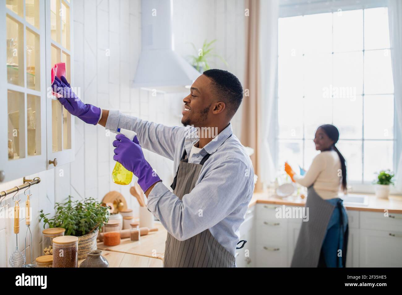 man cleaning kitchen counter stock photos - OFFSET