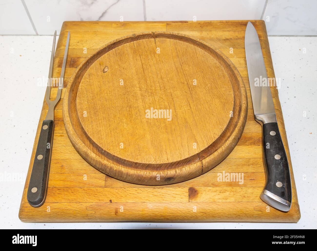 Carving Knife and fork on wooden Carving Board. Stock Photo