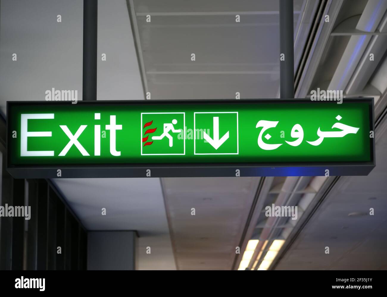 Emergency exit sign in English and Arabic languages Stock Photo Alamy