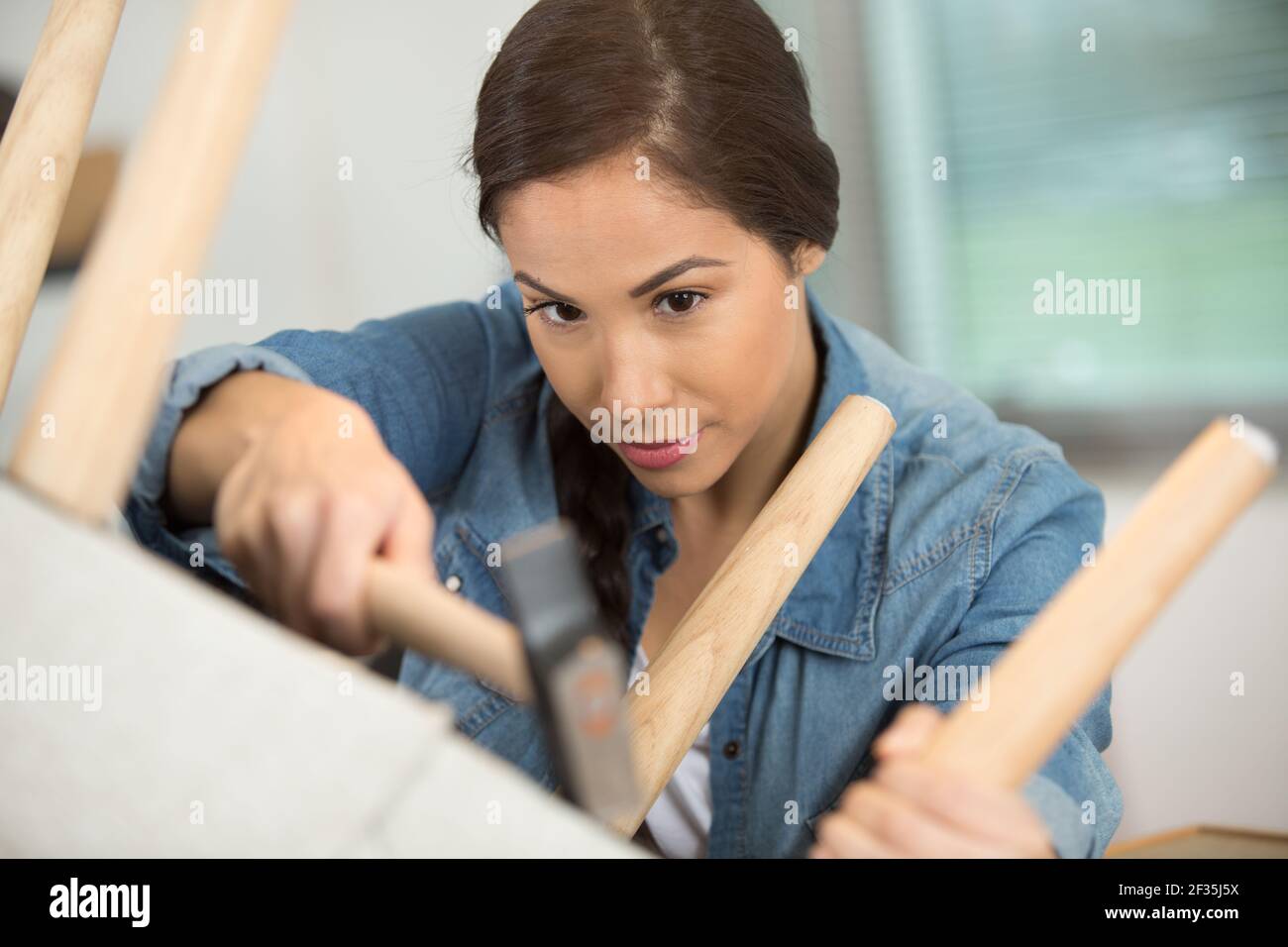 a woman working in upholstery workshop Stock Photo