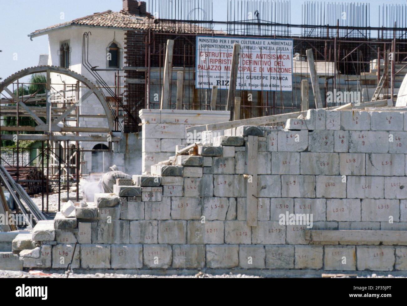 Reconstruction in Friuli (Northern Italy) after the earthquake of May 1976, remaking of the ancient medieval walls of Venzone village  with the original stones (February 1980) Stock Photo