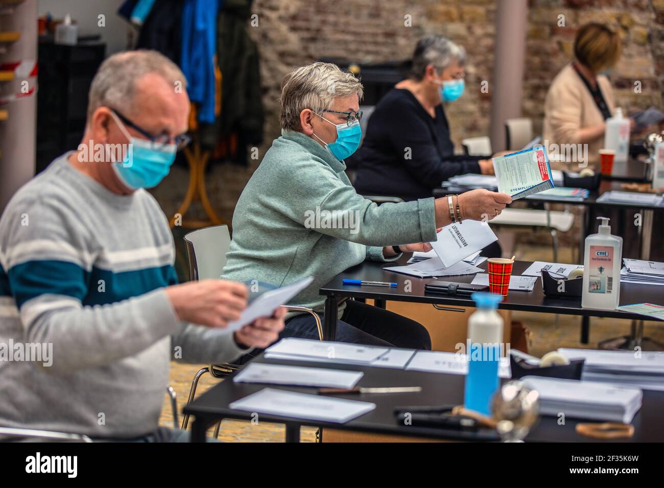 SNEEK, NETHERLANDS – MARCH 15: Polling station clerks are seen opening mail votes on March 15, 2021 in Sneek, Netherlands during the 2021 Dutch General Election. Wednesday is officially election day, but polling stations have already opened on Monday to give the elderly and vulnerable groups the opportunity to avoid the crowds of voters on Wednesday. First, all mail vote envelopes are opened and checked for irregularities.  (Photo by Niels De Vries/BSR Agency/Alamy Live News) Stock Photo