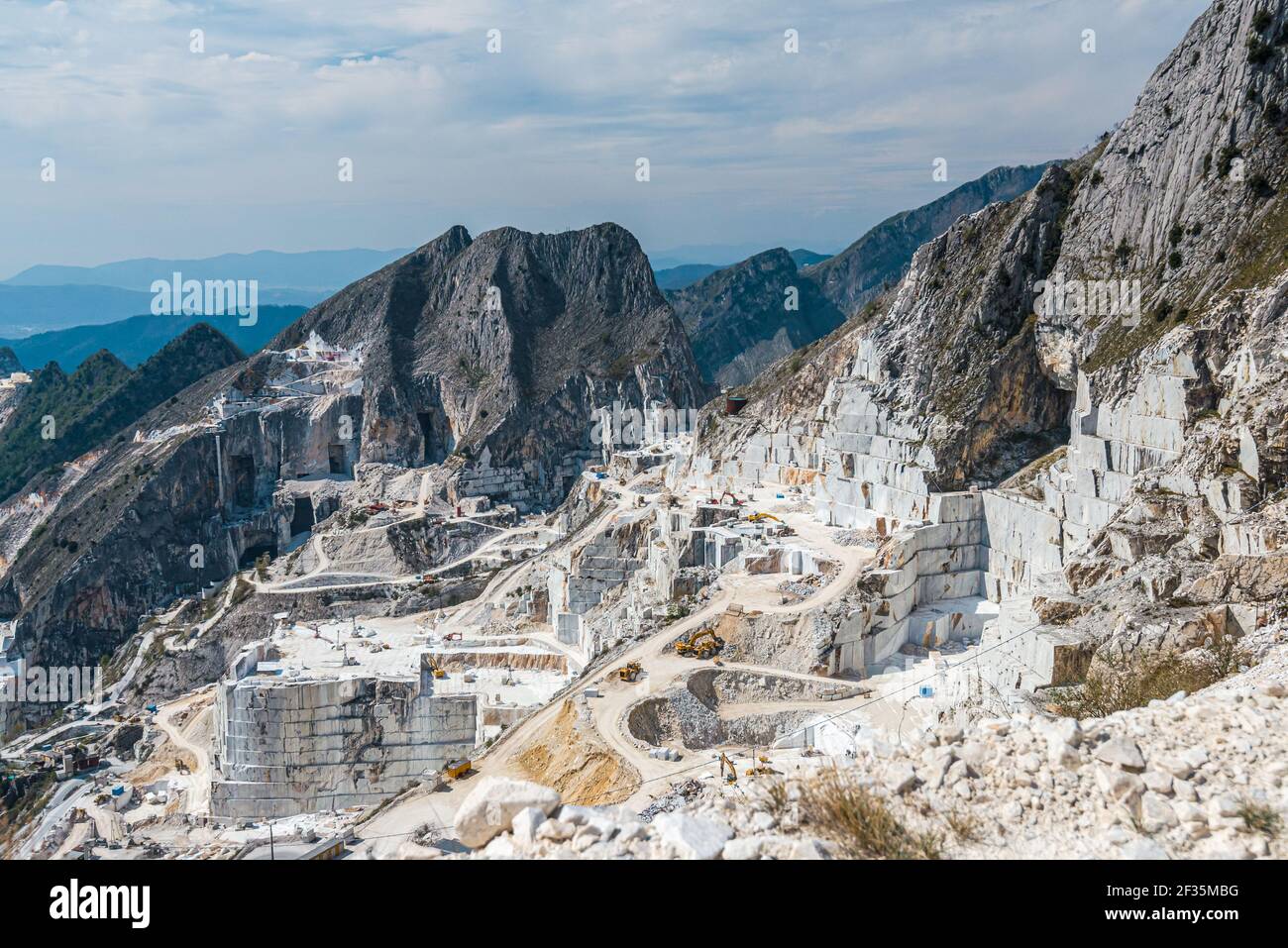 Carrara marble quarry site, net of dust road among huge stone blocks
