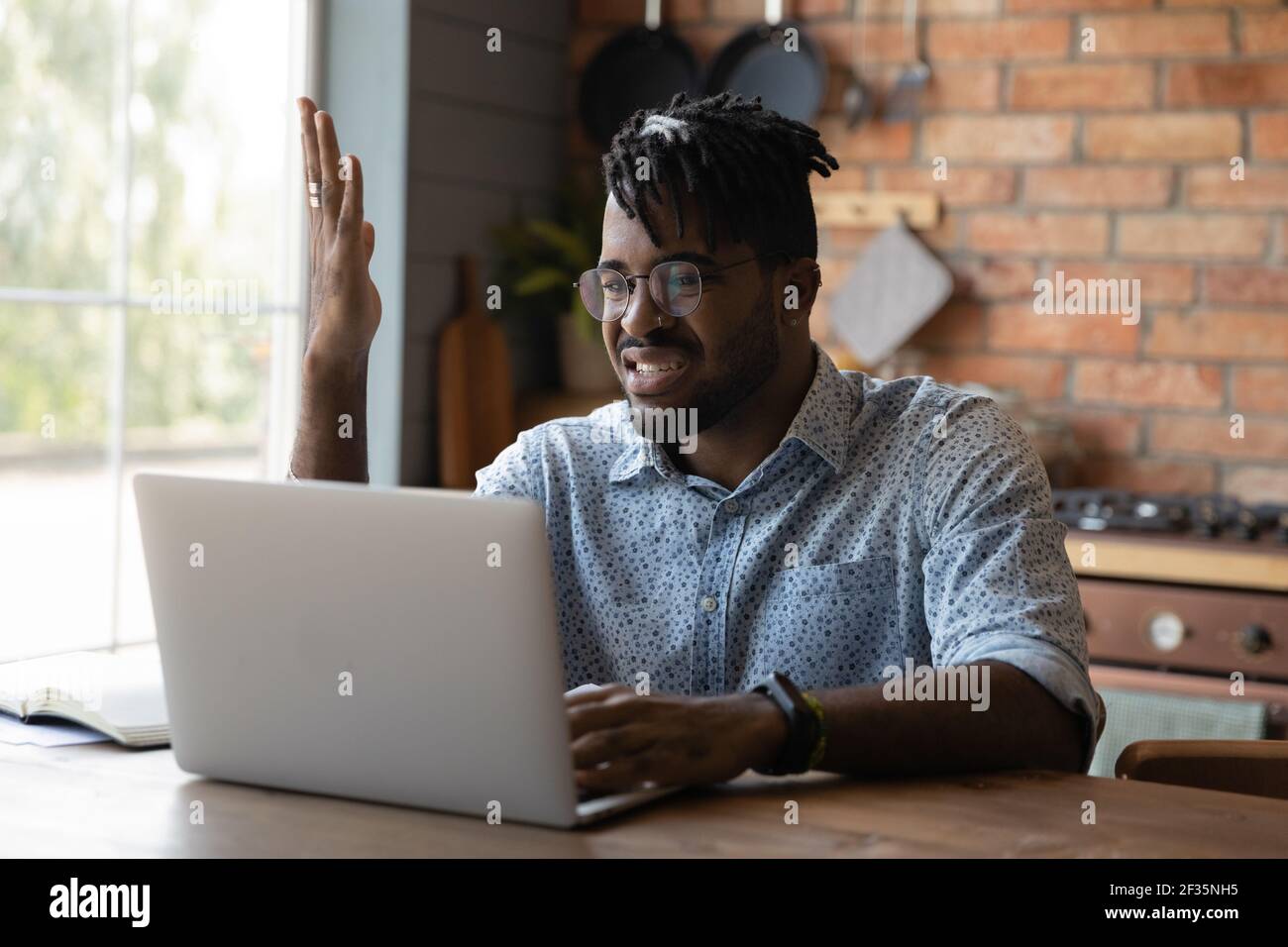 Nervous young black male angry with spam on laptop screen Stock Photo