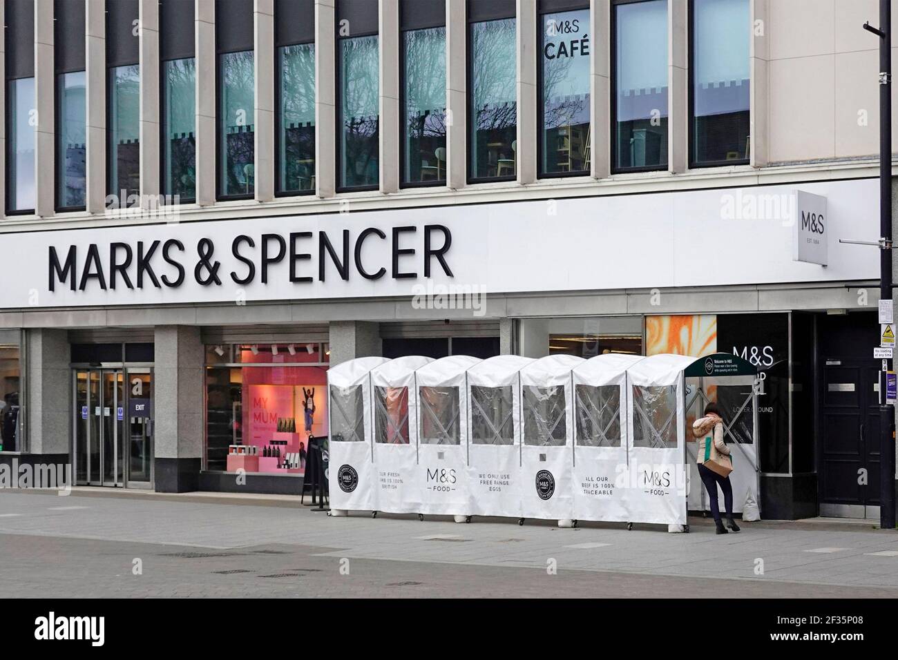 Marks and Spencer shop front & collapsible all weather shopper queue shelter one way M&S store entrance for coronavirus corvid 19 pandemic Essex uk Stock Photo