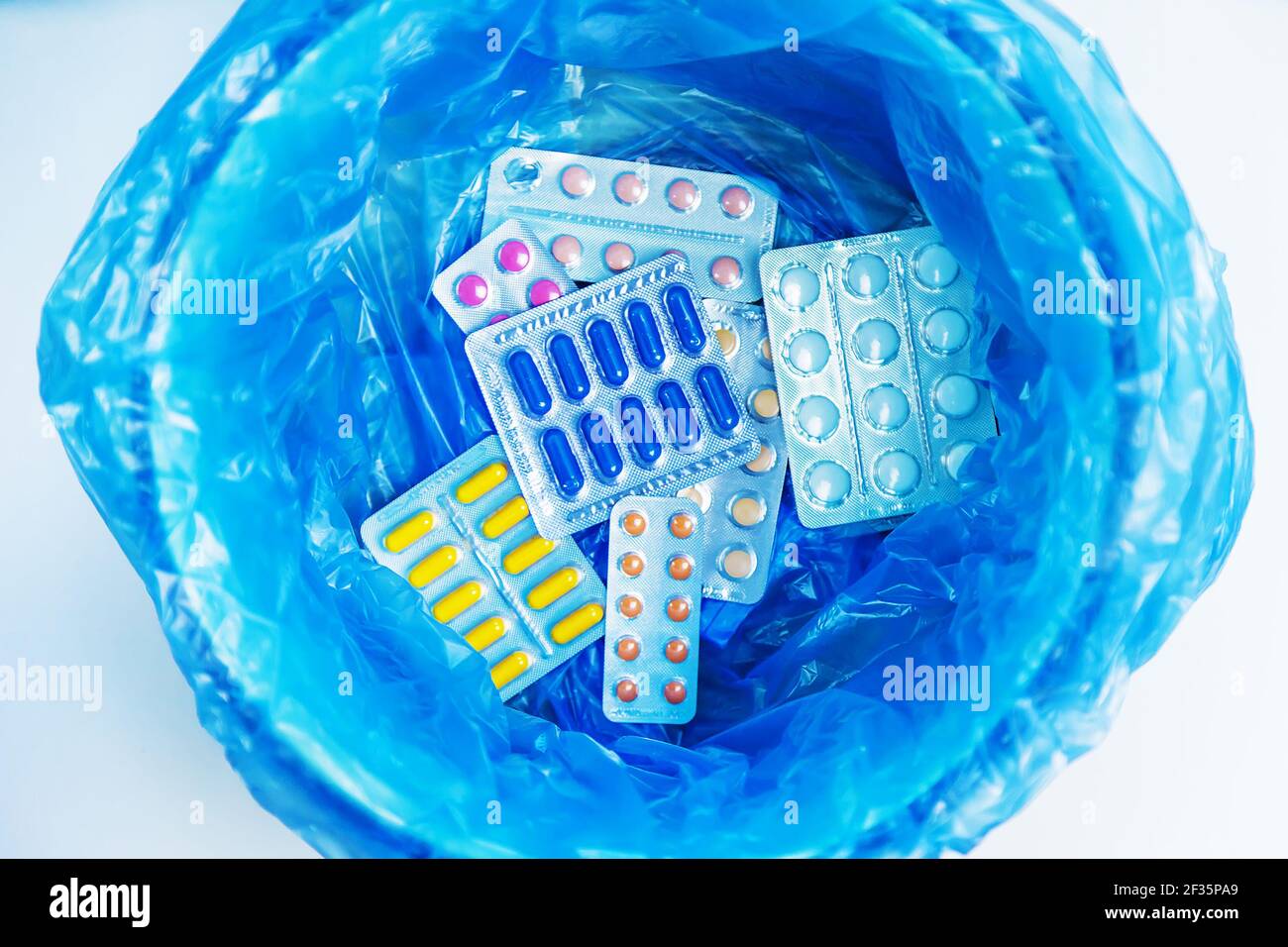 Throw away the tablets in the trash bin. Selective focus. medicine
