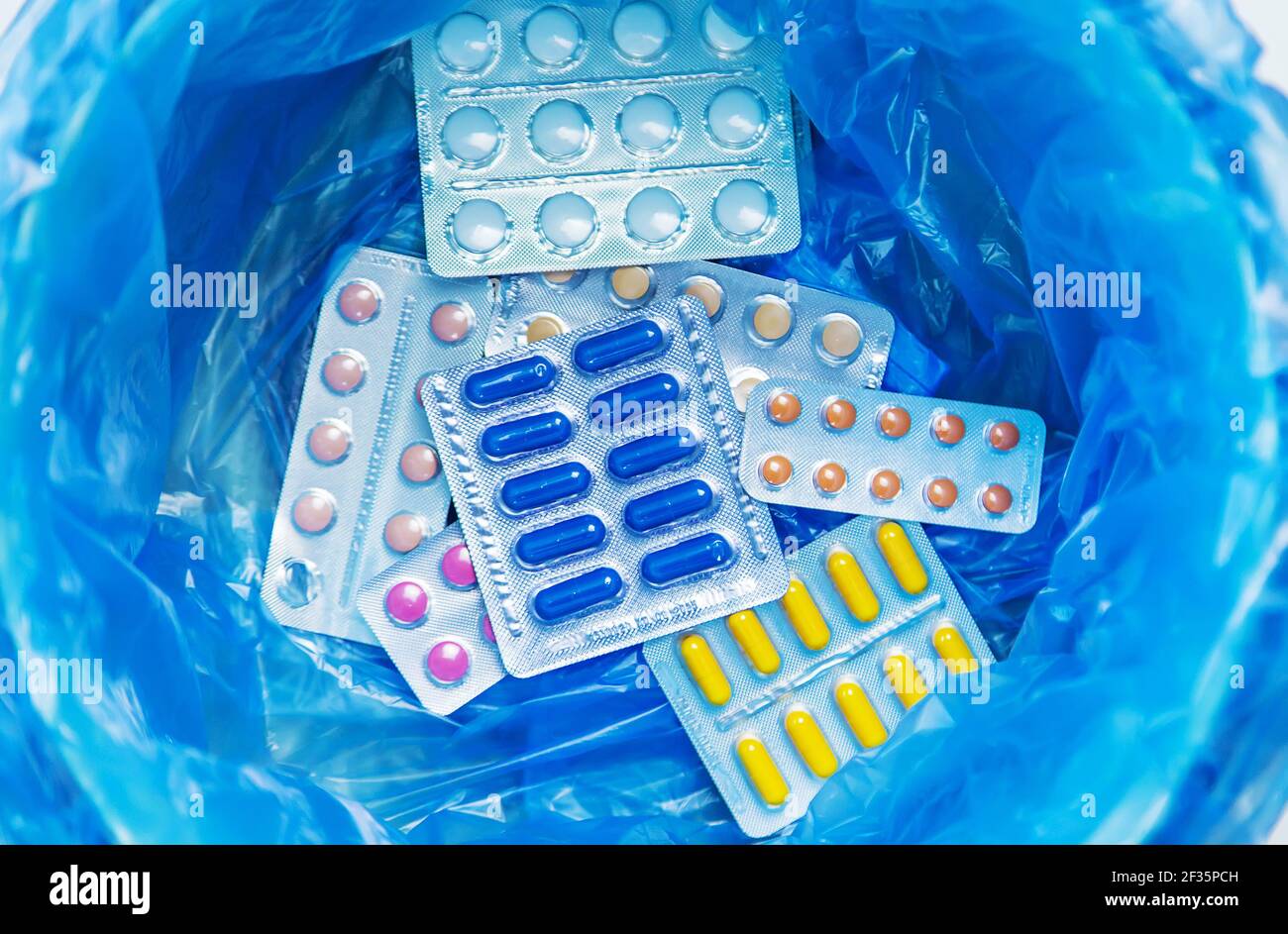 Throw away the tablets in the trash bin. Selective focus. medicine