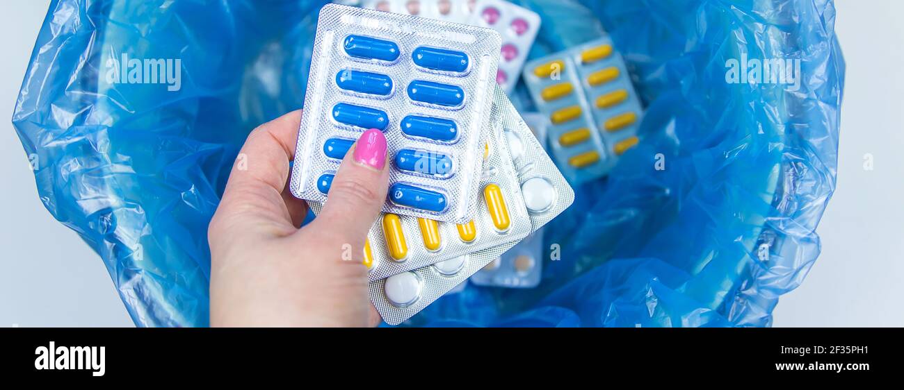 Throw away the tablets in the trash bin. Selective focus. medicine
