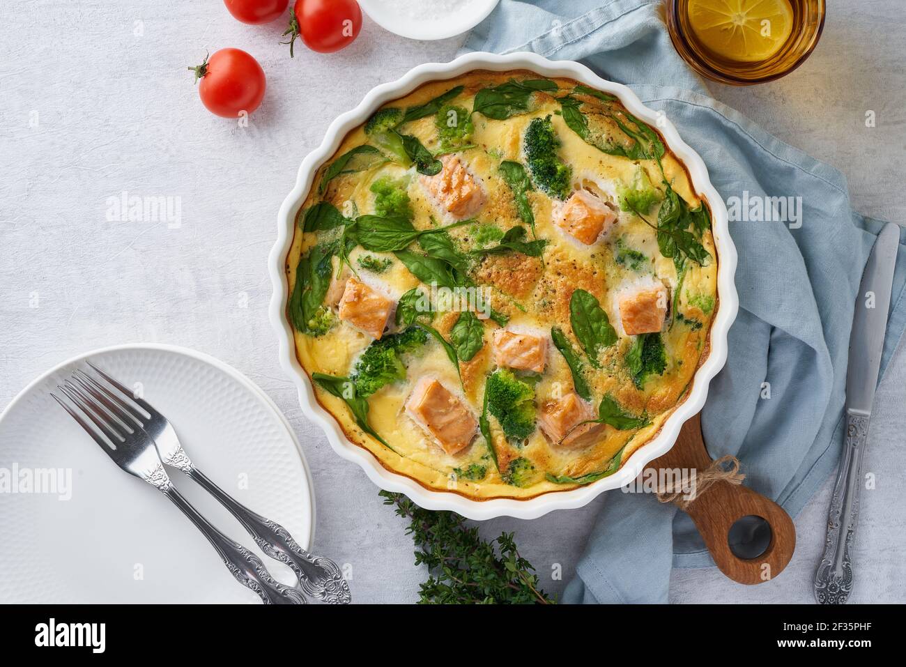 Eggbased frittata, omelette with salmon, broccoli and spinach, top view, copy space Stock Photo