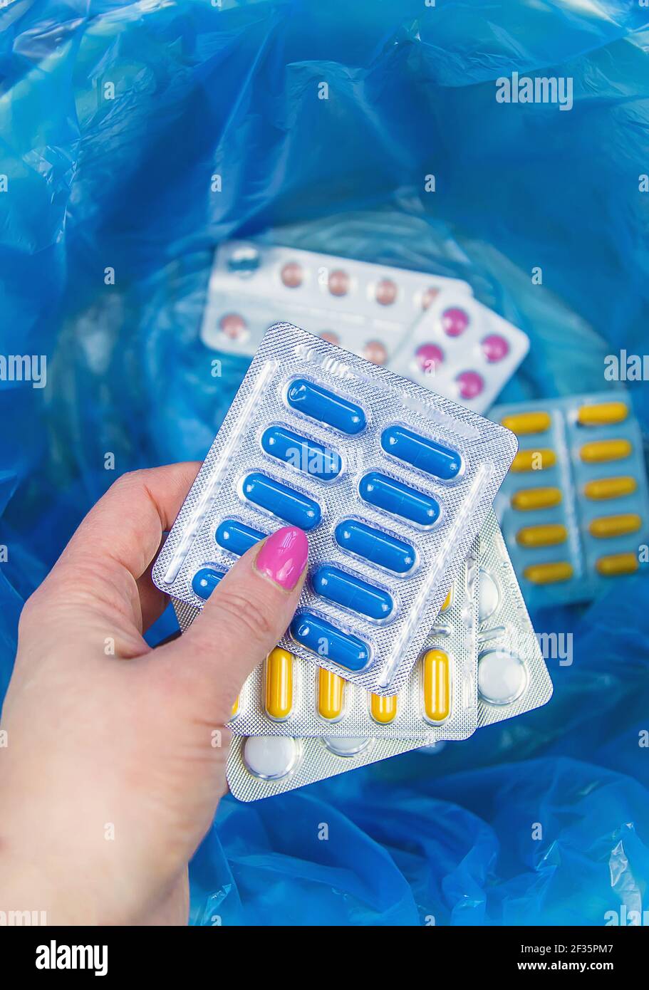 Throw away the tablets in the trash bin. Selective focus. medicine