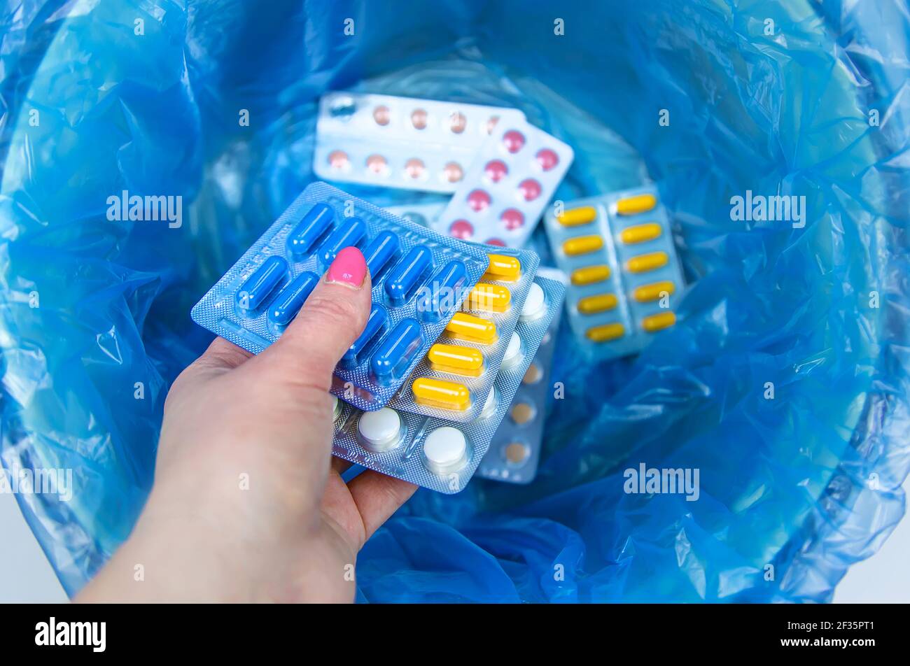 Throw away the tablets in the trash bin. Selective focus. medicine