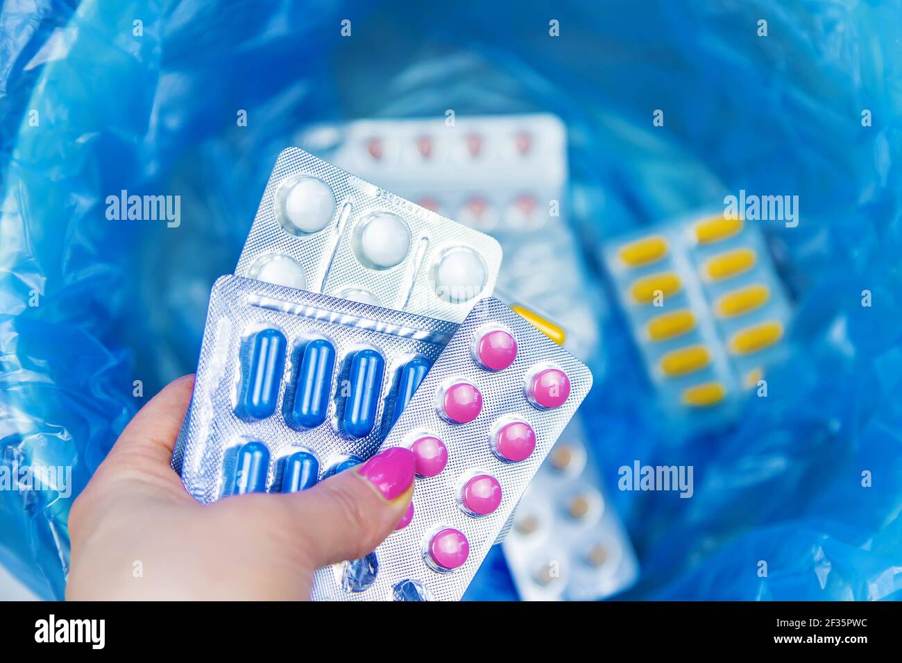 Throw away the tablets in the trash bin. Selective focus. medicine
