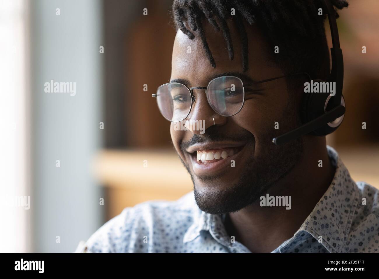 Friendly black man call center operator in headphones contact client Stock Photo