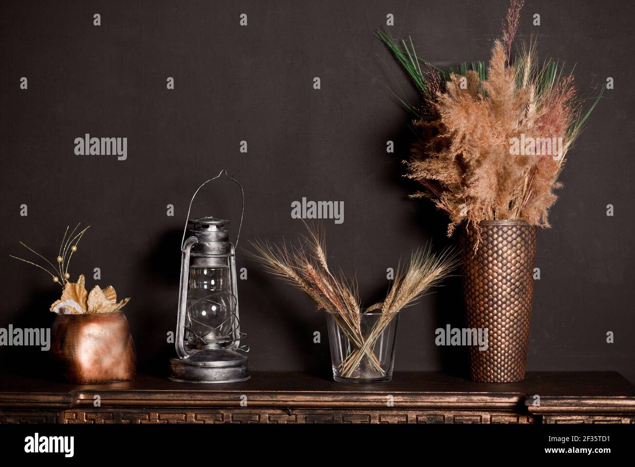 https://c8.alamy.com/comp/2F35TD1/wooden-shelf-with-different-home-related-objects-on-the-dark-wall-background-2F35TD1.jpg