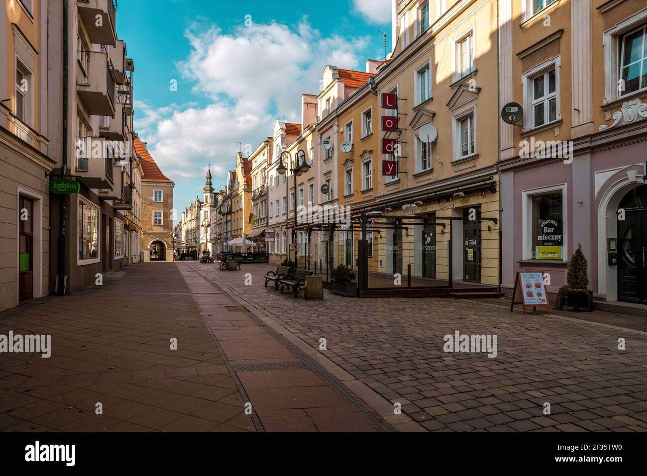 OPOLE, POLAND - Mar 06, 2021: a cobbled street in the city of Opole in Silesia with shops and tenement houses Stock Photo