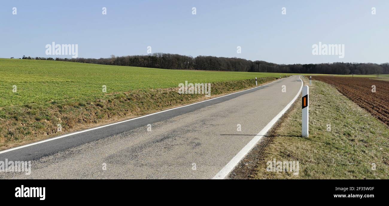 Asphalt road among meadows and fields in the countryside Stock Photo ...