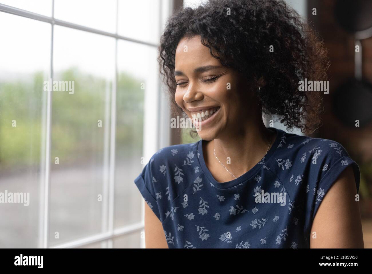 Millennial black woman laugh with closed eyes feel happy Stock Photo
