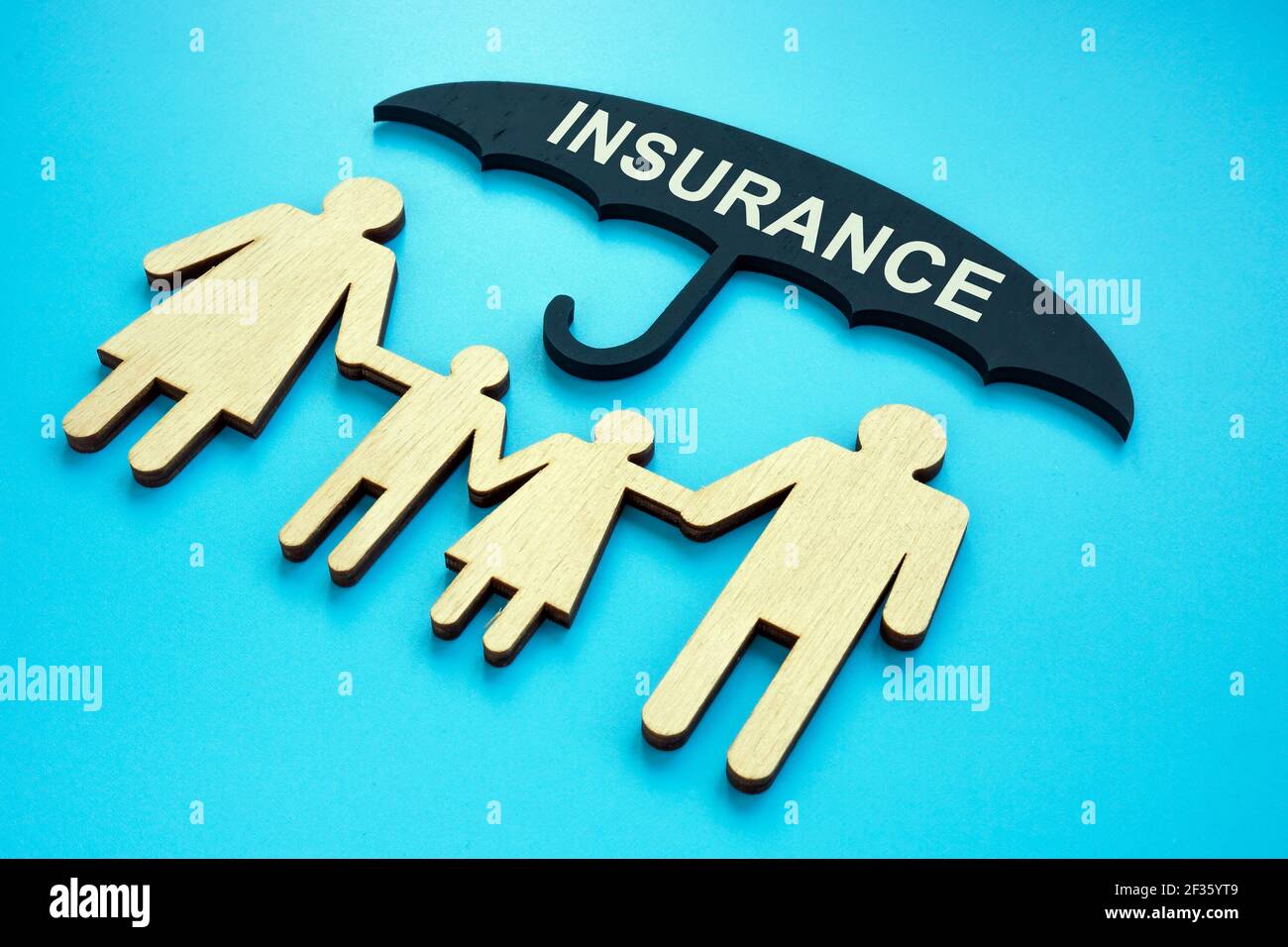 Life insurance concept. An umbrella over the family. Stock Photo