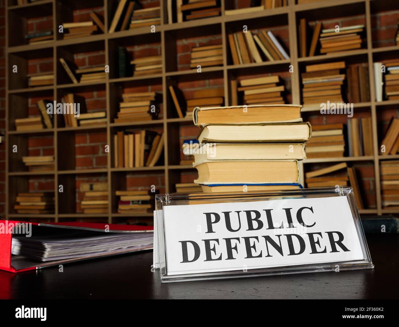 Nameplate public defender and stack of book. Stock Photo