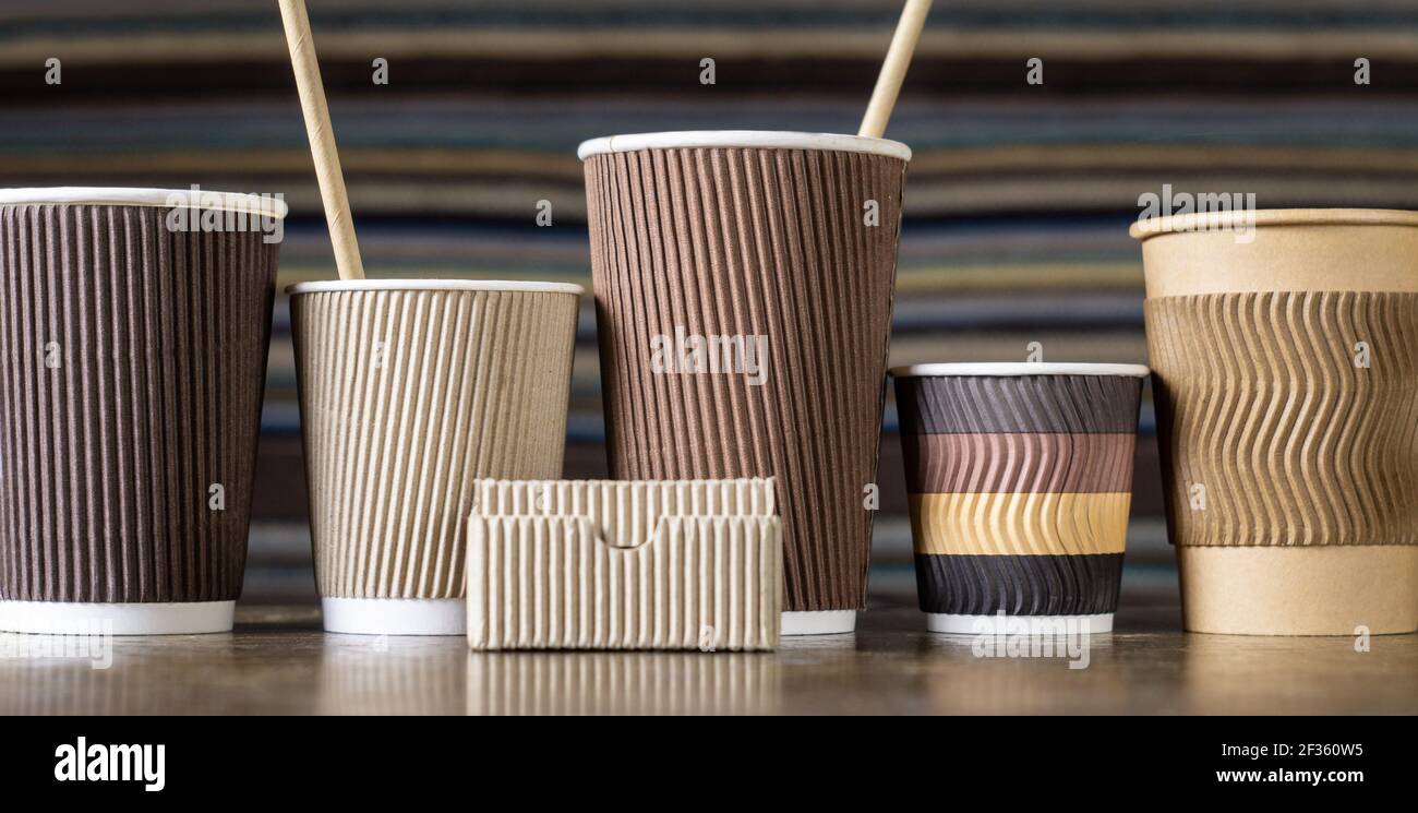 Big and small disposable paper coffee cups in different colors and ...