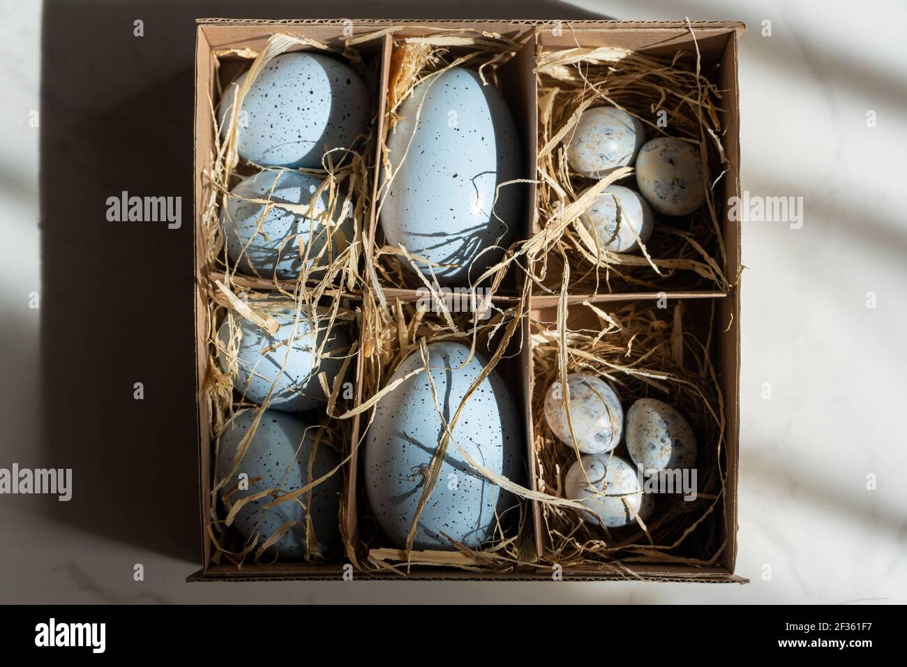 Easter background with Easter eggs in box with the hay, Easter card with copy space for text. Stock Photo