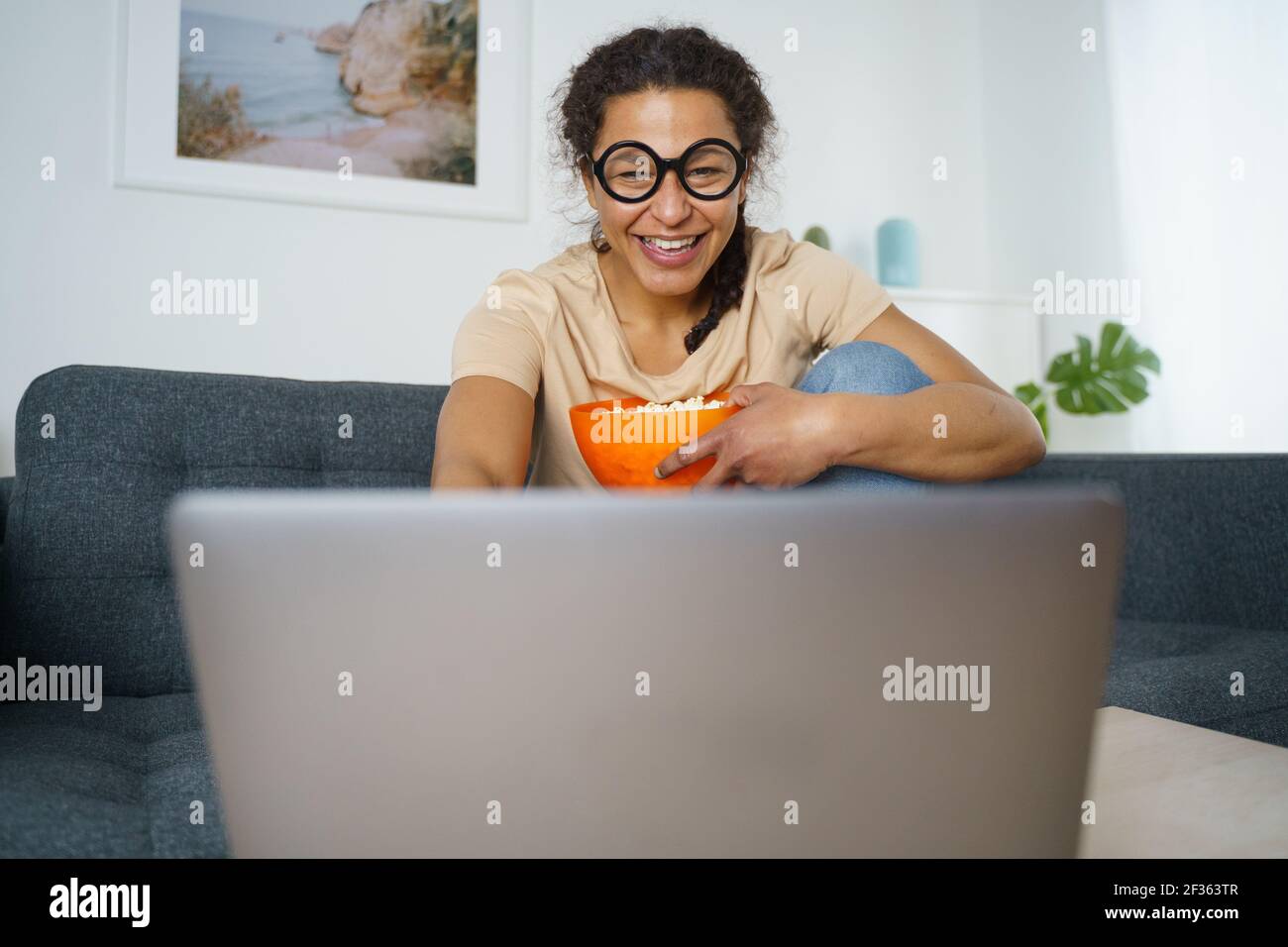 Cheerful african american woman watching streaming youtube Stock Photo