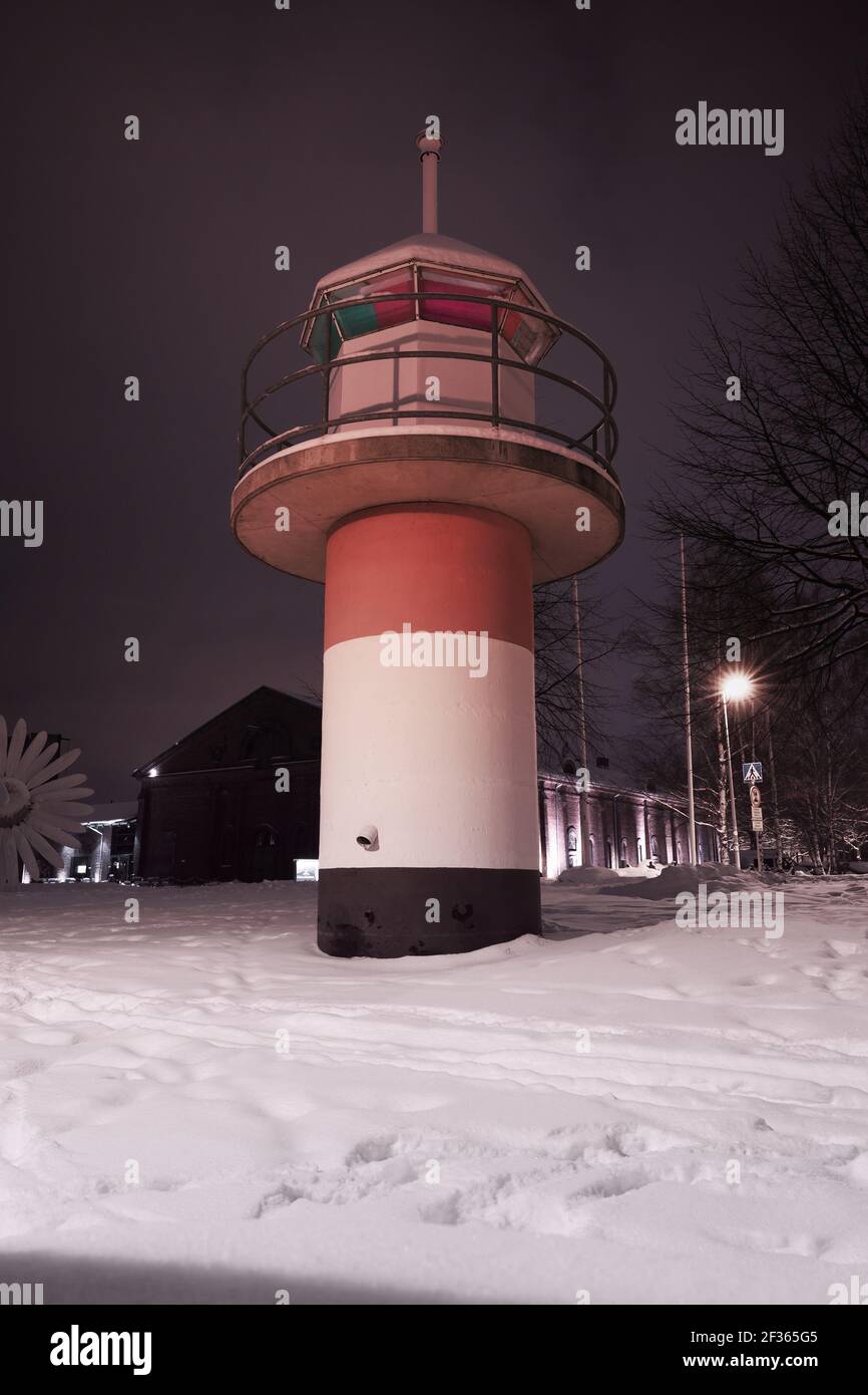 Red white lighthouse tower at winter night. Port of Turku, Finland Stock Photo