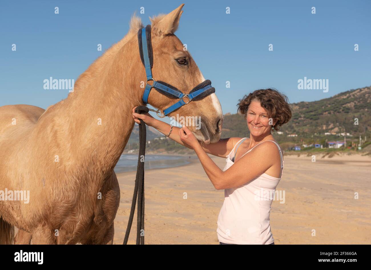 Woman with her horse at the beach, Tarifa, Costa de la Luz, Cadiz, Andalusia, Southern Spain. Stock Photo