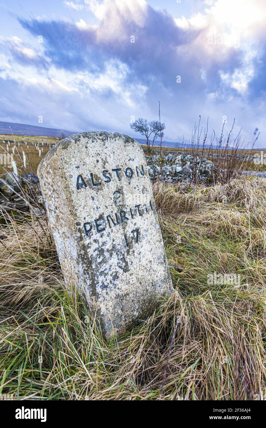 An old milestone on the North Pennines in winter near Alston, Cumbria UK Stock Photo
