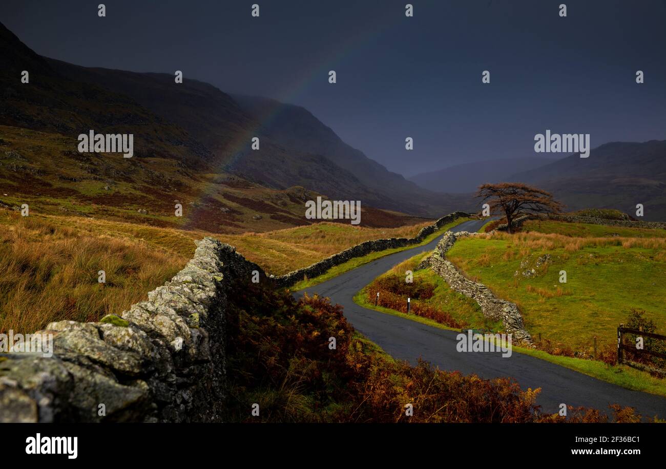 Rainbow against dark clouds hi-res stock photography and images - Alamy