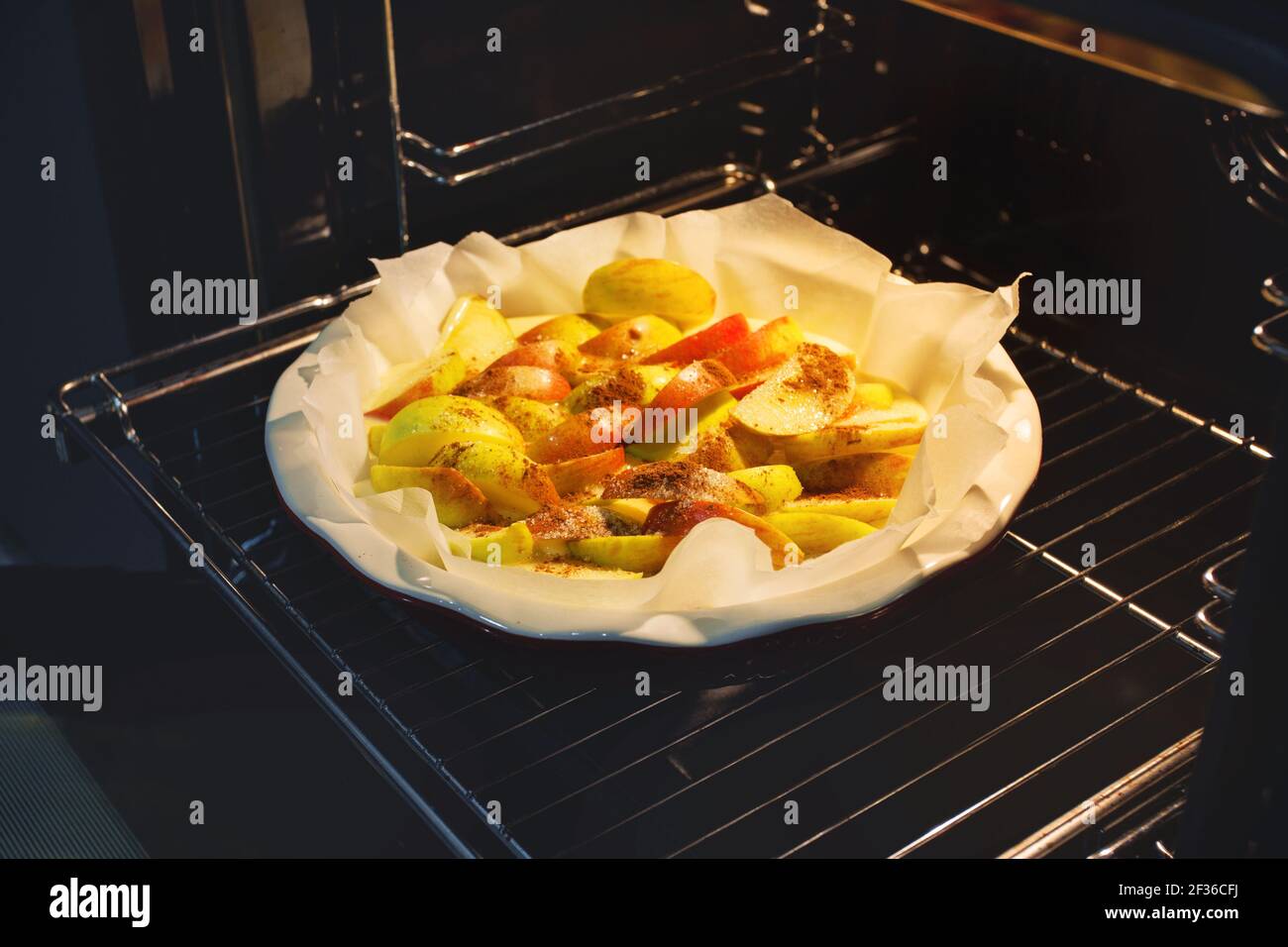 Freshly baked apple pie at home in the oven in the kitchen. Apple Charlotte Homemade baking.  Stock Photo