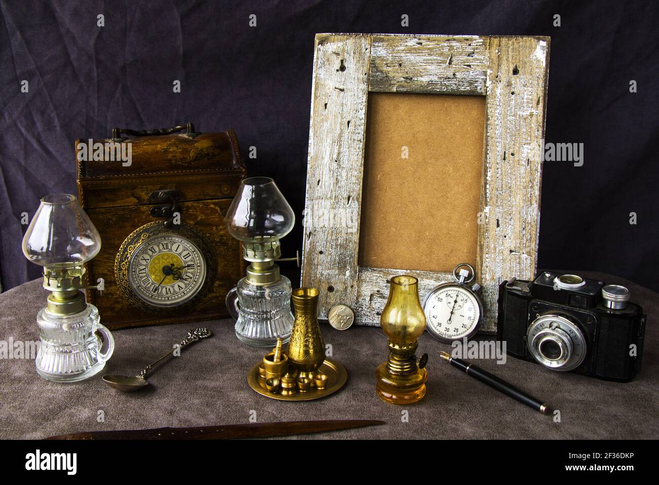 The vintage objects on the table, old box, lamp, clock, pen, and other things Stock Photo