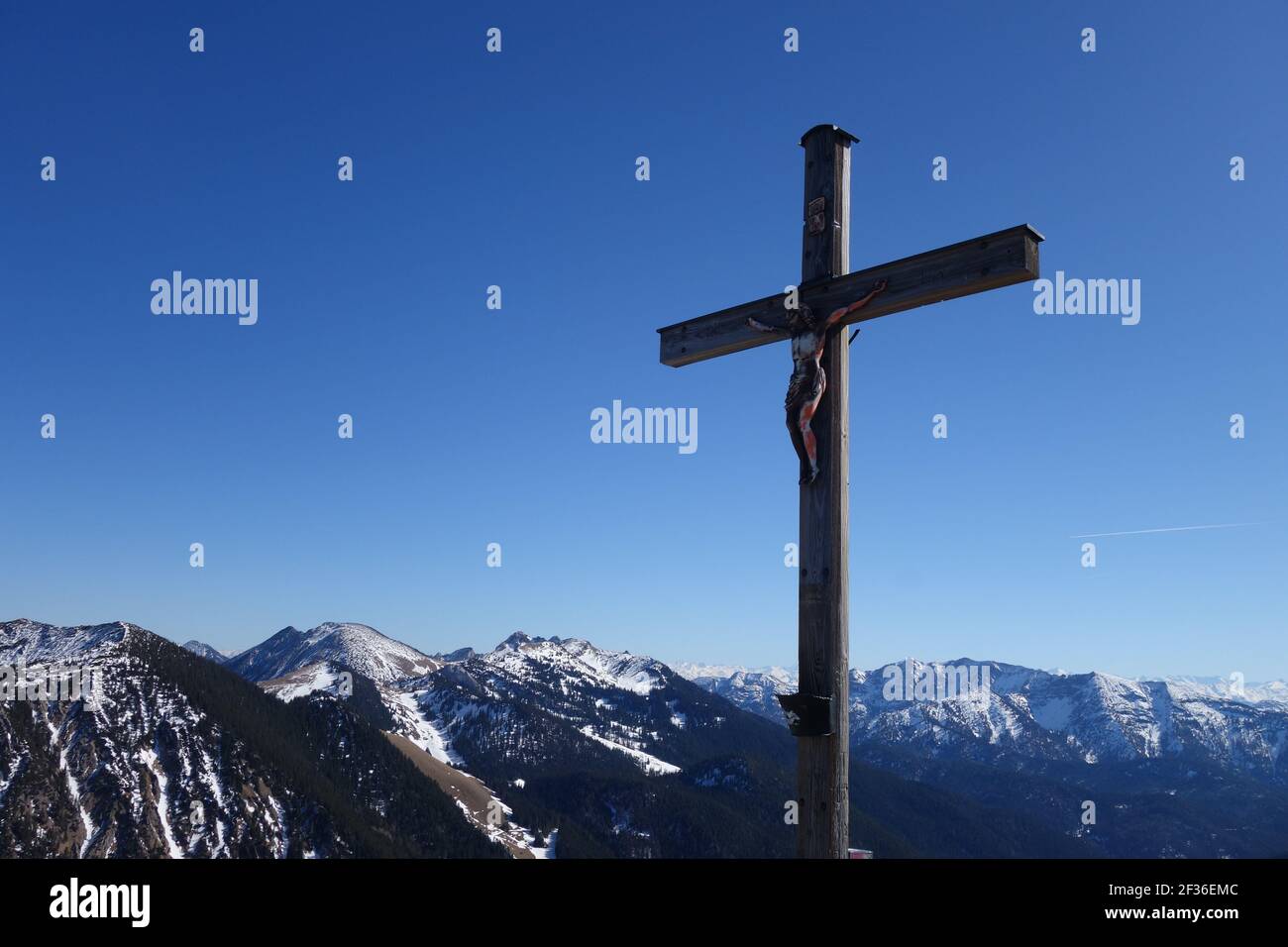A Jesus Christ on the Cross in the mountain against a blue sky Stock ...