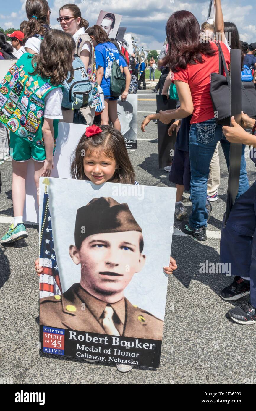Washington DC,National Memorial Day Parade,staging area youth volunteers boy girl scouts Spirit of 45,teens teenagers holding photos honoring WWII vet Stock Photo